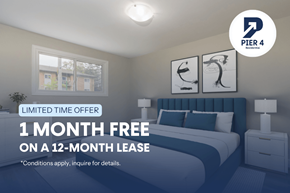 Hamilton apartment for rent - A bedroom with a bed, nightstands, and a window with a view of buildings outside.