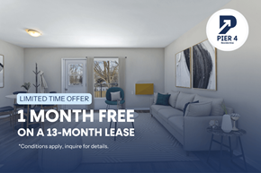 London apartment for rent - A room with a couch and a chair, advertising a free month on a lease.