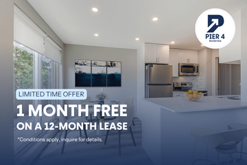 Kitchener apartment for rent - A kitchen interior with a sign offering a free month on a 12-month lease.