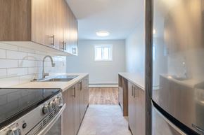 London apartment for rent - A kitchen with a stove top oven and a refrigerator.