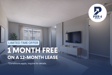 Kitchener townhouse for rent - A room with a TV and a window is being advertised for a free month on a 12-month lease.