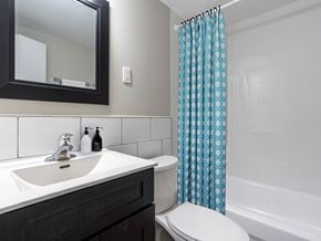 London apartment for rent - A white toilet sits next to a sink in a bathroom.