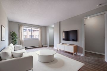 Kitchener townhouse for rent - A living room with a white couch and a television.