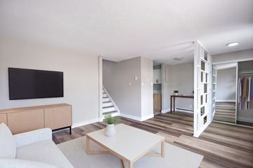 Kitchener townhouse for rent - A living room with a white couch and a wooden coffee table.