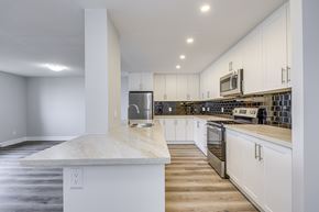 Waterloo apartment for rent - A kitchen with white cabinets and a marble countertop.