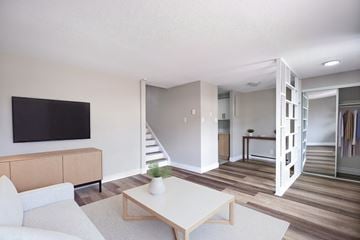 Kitchener townhouse for rent - A living room with a white couch and a wooden coffee table.