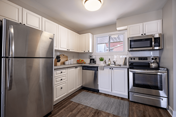 Kitchener townhouse for rent - A kitchen with a stainless steel refrigerator and oven.