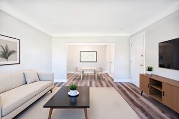 Hamilton apartment for rent - A living room with a couch, coffee table, and a painting on the wall.