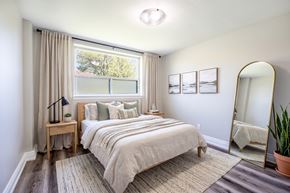 Hamilton apartment for rent - A bedroom with a large bed and a window with curtains.