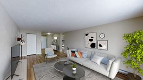 Moncton apartment for rent - A living room with a white couch and a television.