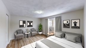Moncton apartment for rent - A bedroom with a large bed, two chairs, a table, and three pictures on the wall.