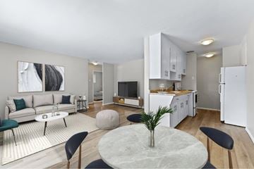 London apartment for rent - A modern living room with a grey marble table and black chairs.