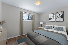 London apartment for rent - A bedroom with a large bed and two pictures on the wall.