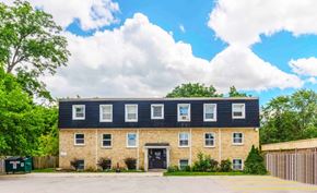 London apartment for rent - A building with a black roof and a yellow line in front of it.