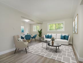 Kitchener apartment for rent - A living room with a white couch, a grey chair, and a coffee table.