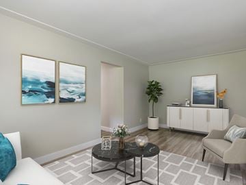 Kitchener apartment for rent - A living room with a white couch, a black coffee table, and two paintings on the wall.