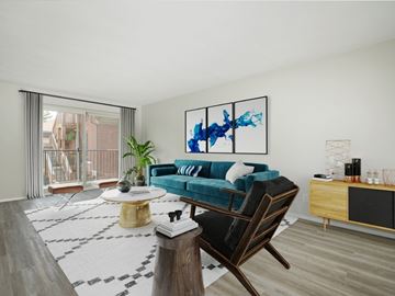London apartment for rent - A living room with a blue couch and a painting on the wall.