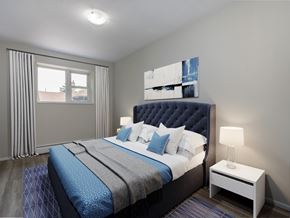 London apartment for rent - A bedroom with a large bed and a nightstand with a lamp.