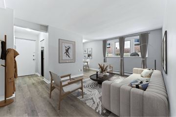 London apartment for rent - A living room with a grey sofa and a wooden chair.
