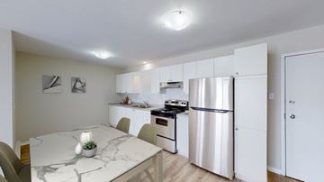 Moncton apartment for rent - A kitchen with a refrigerator, stove, and oven.