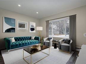 London apartment for rent - A living room with a green couch, a coffee table, and a window with curtains.