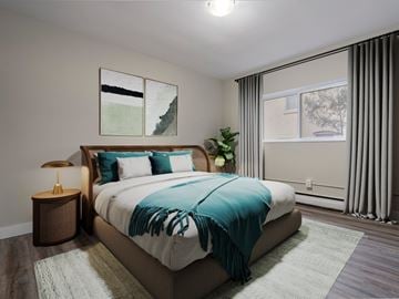 London apartment for rent - A bedroom with a large bed and a lamp on a side table.