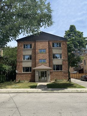 London apartment for rent - A brick building with a black roof and a small porch.