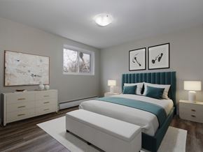 Kitchener apartment for rent - A bedroom with a large bed and a painting on the wall.