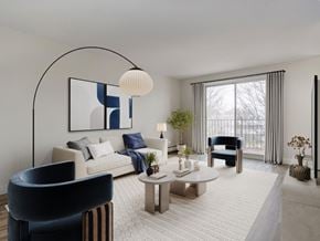 Kitchener apartment for rent - A modern living room with a large window and a blue chair.