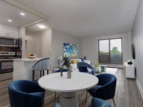 London apartment for rent - A modern dining room with a white table and blue chairs.