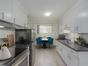 Kitchener apartment for rent - A kitchen with white cabinets and a black refrigerator.