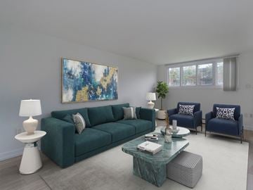 Kitchener apartment for rent - A living room with a green couch and a painting on the wall.