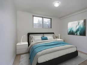 Kitchener apartment for rent - A bedroom with a large bed and a painting on the wall.