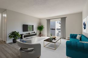 Halifax apartment for rent - A living room with a grey chair, a blue couch, and a television.