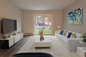 Bedford apartment for rent - A living room with a white couch, a television, and a painting on the wall.