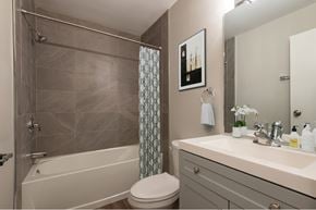 Bedford apartment for rent - A bathroom with a toilet, sink, and shower.