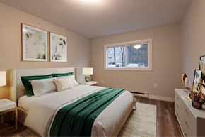 Bedford apartment for rent - A bedroom with a bed, nightstand, and two framed pictures on the wall.