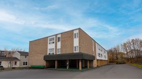 Halifax apartment for rent - A large building with a parking lot in front.