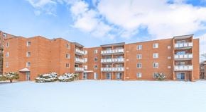Thorold apartment for rent - A red brick building with a snowy ground in front.
