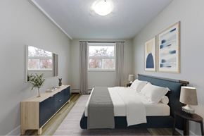Cambridge apartment for rent - A bedroom with a bed, nightstand, and a plant on the side table.