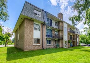 Cambridge apartment for rent - A large brick building with a balcony on the second floor.