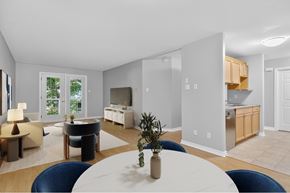 Moncton apartment for rent - A modern dining room with a white table and blue chairs.