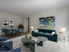 Hamilton apartment for rent - A living room with a green couch and a painting on the wall.