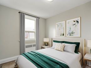Hamilton apartment for rent - A bedroom with a large bed and two framed pictures on the wall.