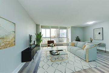 Waterloo apartment for rent - A living room with a blue couch and a coffee table.