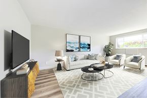 Kitchener apartment for rent - A living room with a television, a couch, and a coffee table.
