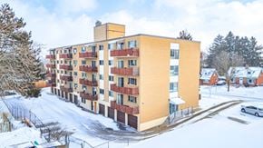 Kitchener apartment for rent - A large apartment building with a snowy landscape in front.