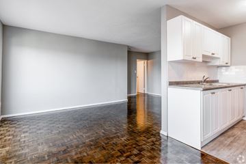 Hamilton apartment for rent - A kitchen with white cabinets and a wooden floor.