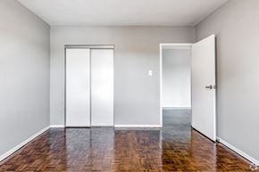 Hamilton apartment for rent - A room with a sliding door and a wooden floor.