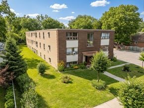 London apartment for rent - A large brick building with a green lawn in front.